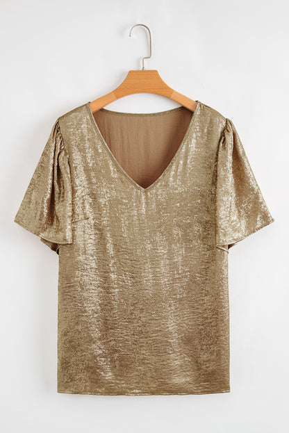 Gold metallic top on a wooden hanger against a white background